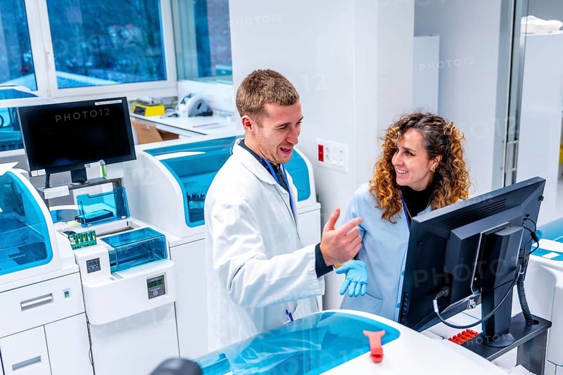 Young scientists working using computer in a modern laboratory of an hospital in the pathology area