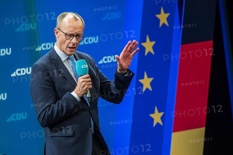 Election event of the CDU party for the Bundestag elections with top candidate Friedrich Merz. Portrait in front of the German flag and the flag of the European Union. Singen am Hohentwiehl. Baden-Württemberg, Germany, Europe