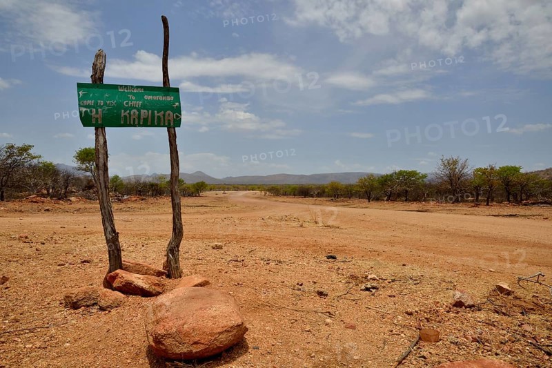 Sign at the entrance to the village of Omuramba, residential village of Chief Hikuminue Kapika, the tribal leader of the Namibian Himba people, Omuramba, Kaokoland, Kunene, Namibia, Africa