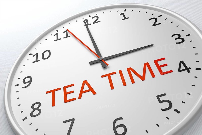 An image of a nice clock with the words tea time