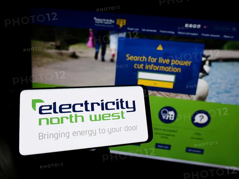 Stuttgart, Germany, 10-28-2023: Person holding mobile phone with logo of British energy company Electricity North West Limited in front of web page. Focus on phone display, Europe