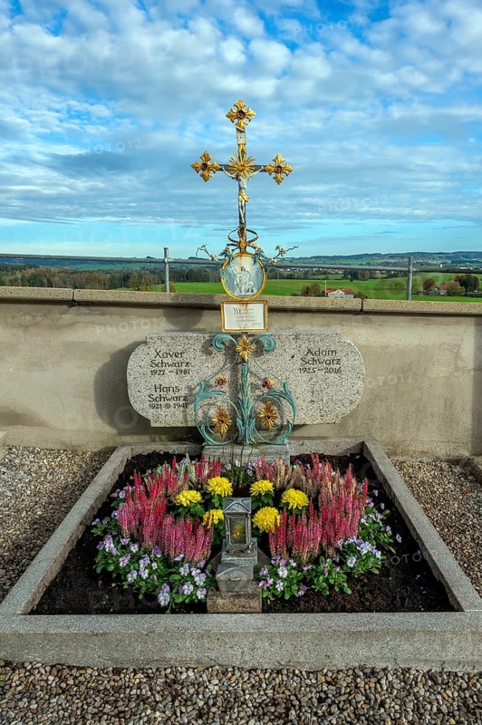 Grave with heather (Erica), near St George and St Florian, a listed Catholic parish church in Reicholzried, Allgäu, Bavaria, Germany, Europe
