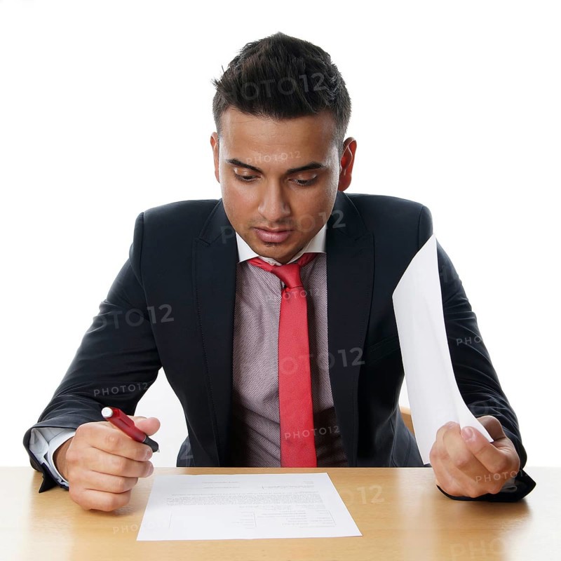 Man reads contract at his desk