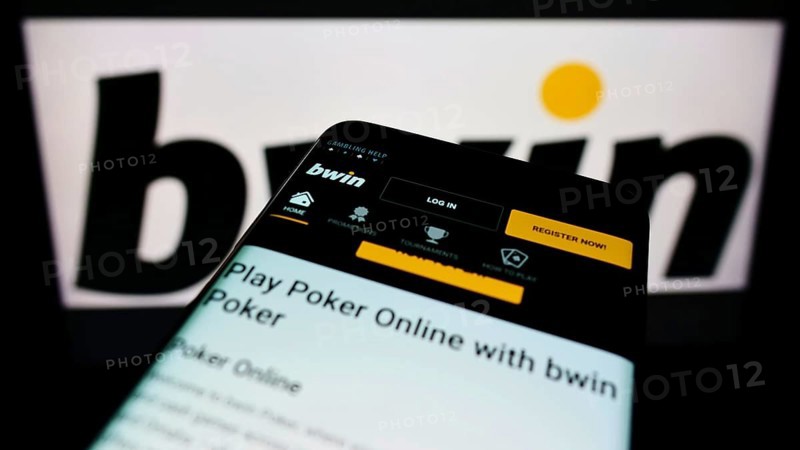 Stuttgart, Germany, 01-08-2022: Mobile phone with webpage of sports betting company bwin Interactive Entertainment on screen in front of logo. Focus on top-left of phone display, Europe