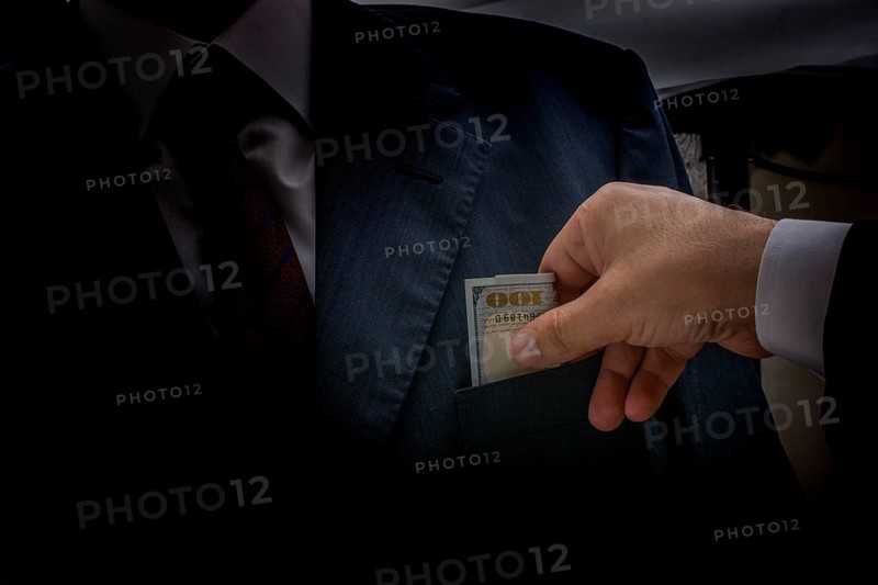 Concept for corruption and bribing fraud finance with Bundle of dollar
