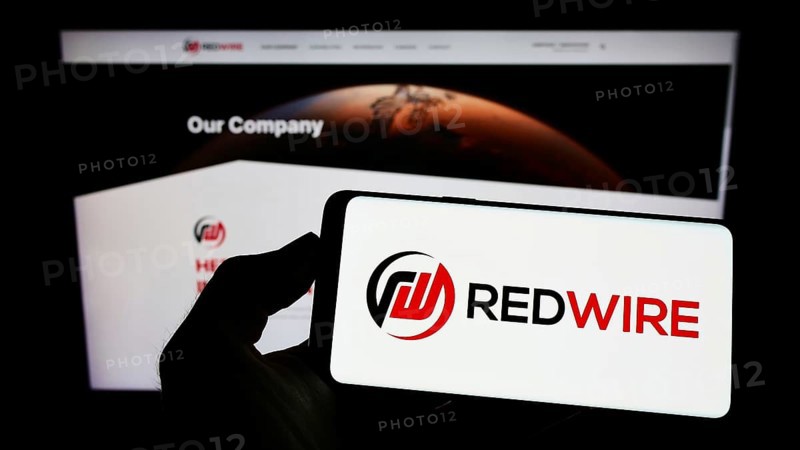 Stuttgart, Germany, 09-04-2022: Person holding mobile phone with logo of American aerospace company Redwire Corporation on screen in front of web page. Focus on phone display, Europe
