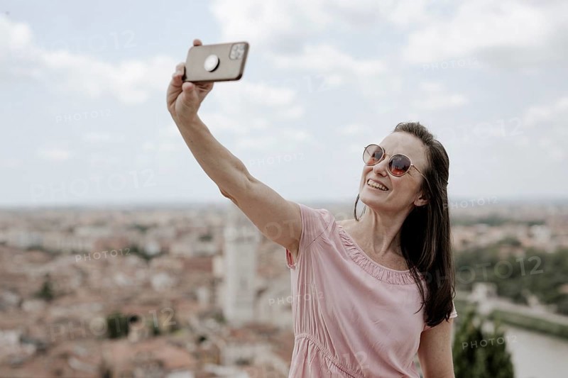 Woman taking a selfie, Verona, Italy, Europe