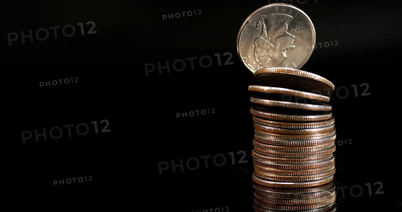 Quarter Dollar Coins Falling, Rolling and Sliding on Black Background