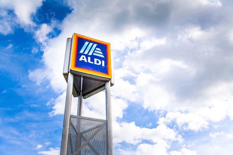 Hockenheim, Germany - June 08, 2022: Commercial sign of ALDI Store against a blue sky. ALDI is a large discount supermarket chain in Germany. It specializes in lower priced products