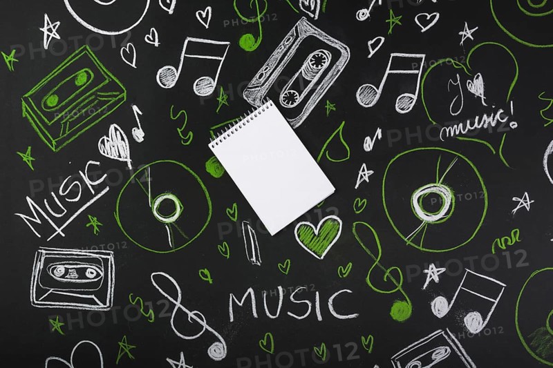 Spiral blank notepad blackboard with drawn musical notes cassette tapes compact discs. Resolution and high quality beautiful photo
