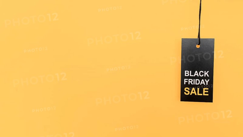 Hanging red black friday sale label copy space yellow background