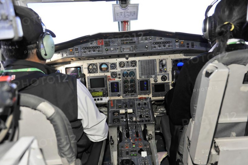 Cockpit of an aeroplane with pilot and numerous control elements, impressions of the great panoramic flight along the Himalayan giants, the roof of the world Kathmandu Nepal