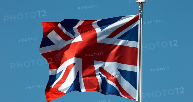 British Flag Waving in the Wind against blue sky