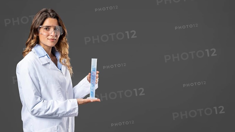 Portrait female doctor using hand sanitizer