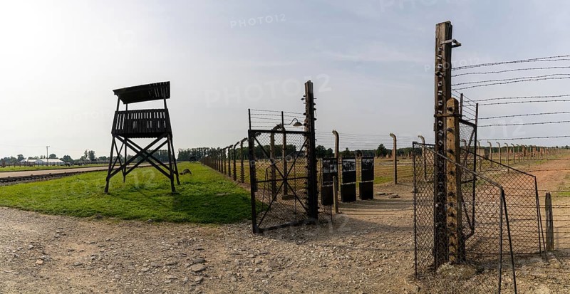 Auschwitz, Poland - 15 September, 2021: guard tower and prison camp gate at Auschwitz concentration camp in Poland