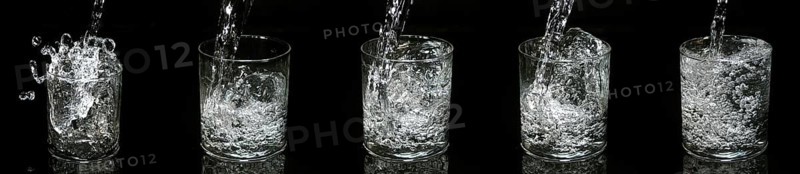 Water being poured into Glass against Black Background