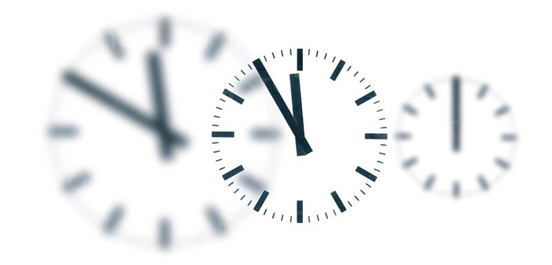 A simple clock or dial, the hands indicating five to twelve and indicating it is high time