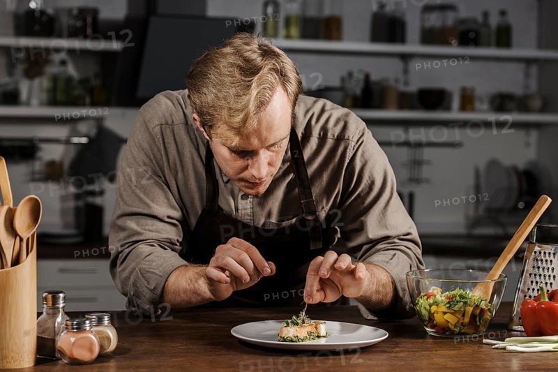 Mid shot chef plating dish