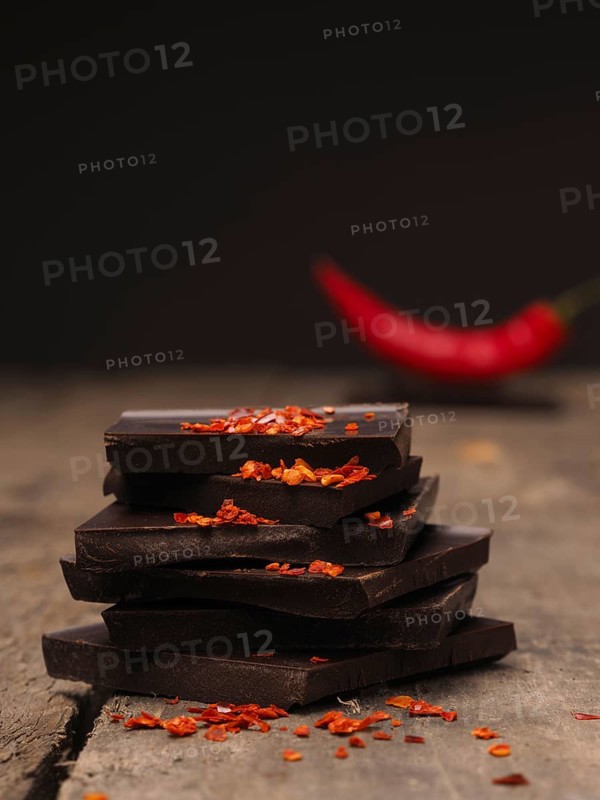 Pile of chocolate with chili flakes on a rustic wooden table