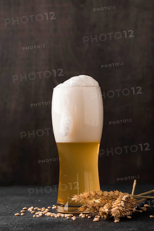 Glass blonde beer with foam