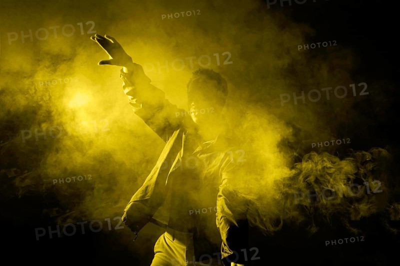 Man dancing smoke with illuminating light