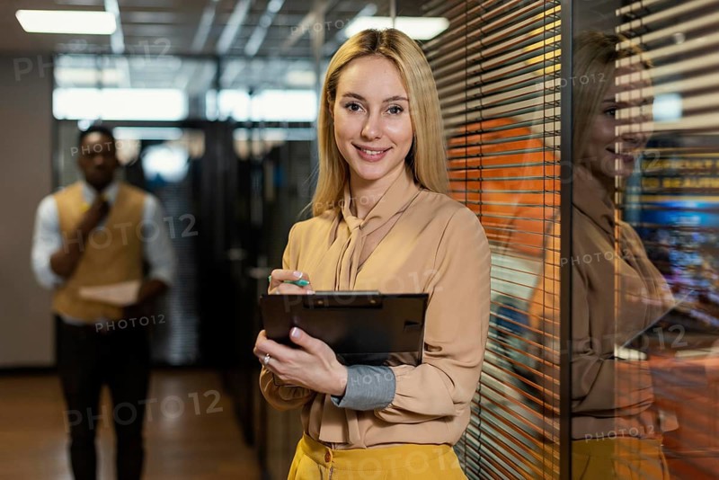 Smiley woman holding clipboard workplace