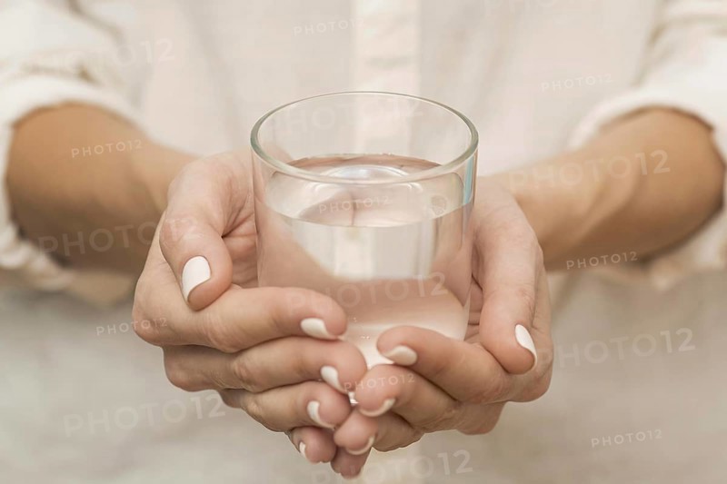 Woman holding glass filled with water. Resolution and high quality beautiful photo