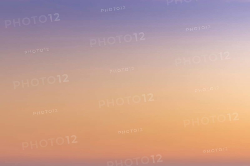 A gradient sunset sky background from orange and red to lilac and blue