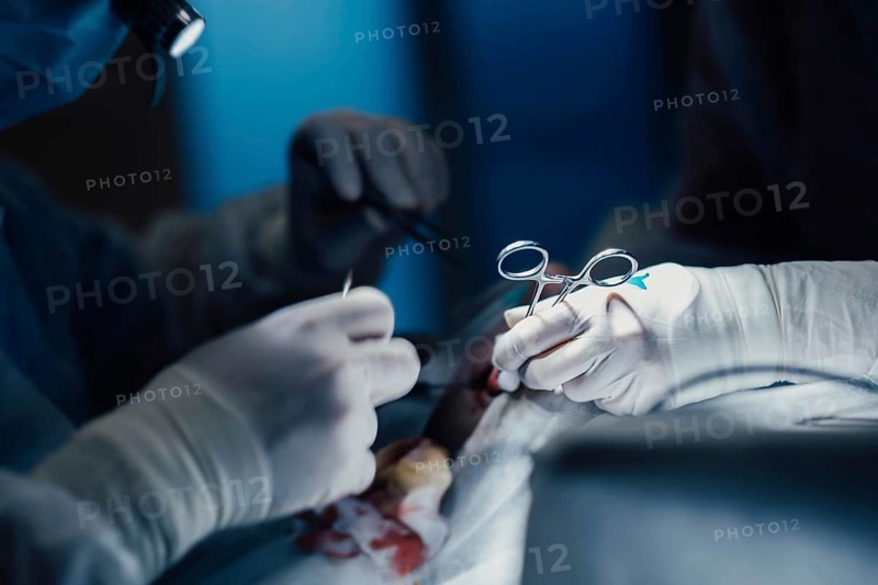 Surgeon operating on patient in operating room close up, surgical operation