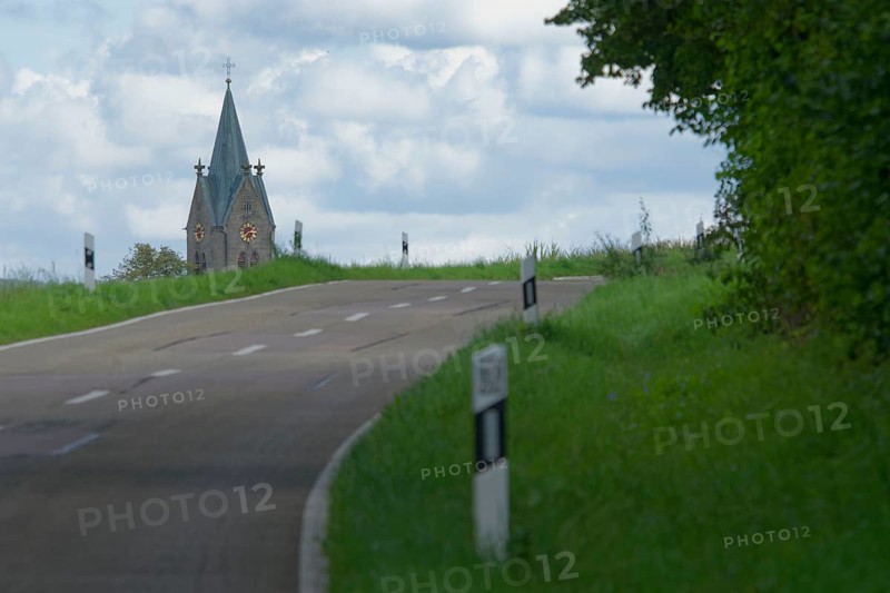 Country road with a view of the village church in Bibersfeld, Swabian-Franconian Forest nature park Park, Schwäbisch Hall, Hohenlohe, Heilbronn-Franconia, Baden-Württemberg, Germany, Europe