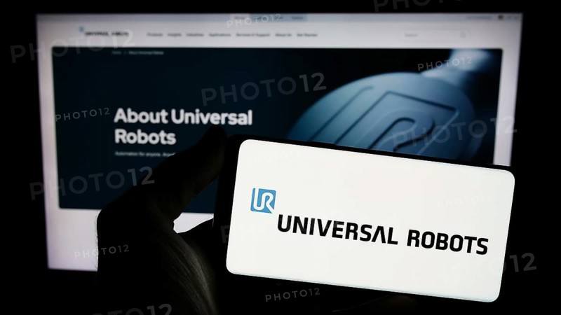 Stuttgart, Germany, 02-12-2024: Person holding smartphone with logo of Danish cobot company Universal Robots AS in front of website. Focus on phone display, Europe