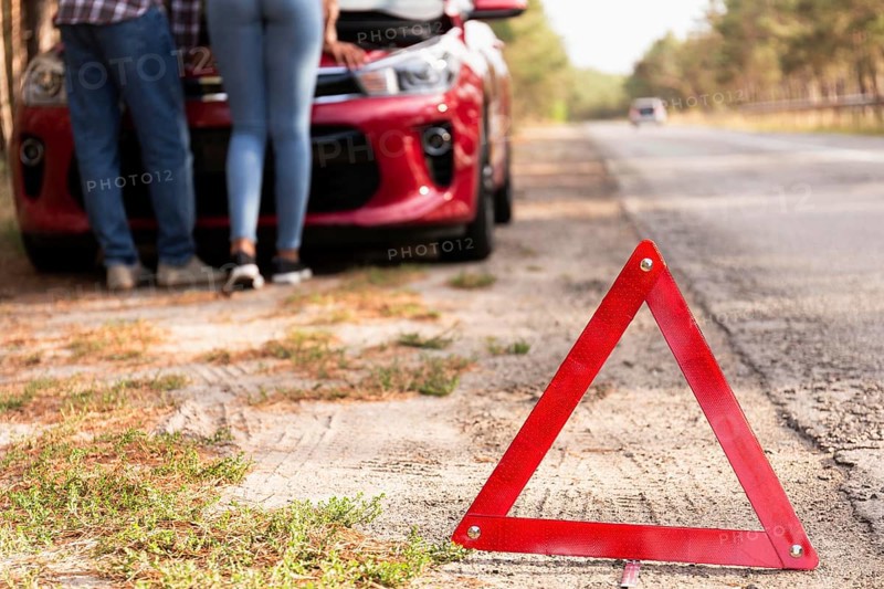 Red triangle sign road car problems while traveling