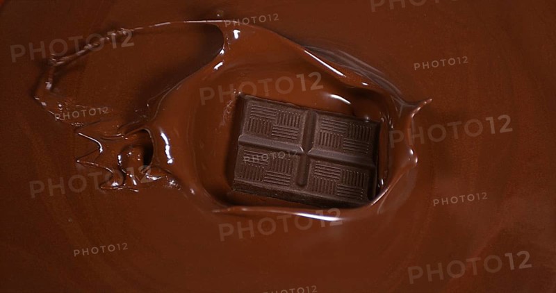Black Chocolate tablet falling into Milk Chocolate