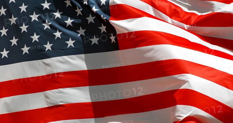 American Flag Waving in the Wind against blue sky