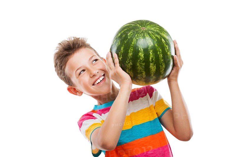 Handsome smiling child boy hand holding green ripe watermelon fruit food white isolated