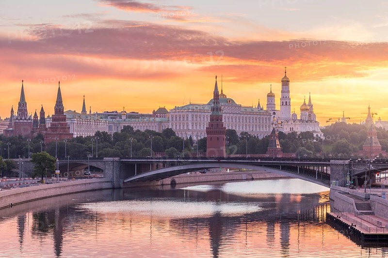 Moscow Kremlin and Moscow River with bridge in the summer sunny morning. Colorful sky. Russia