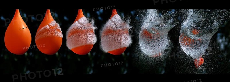 Shot Breaking Water Filled Orange Balloon