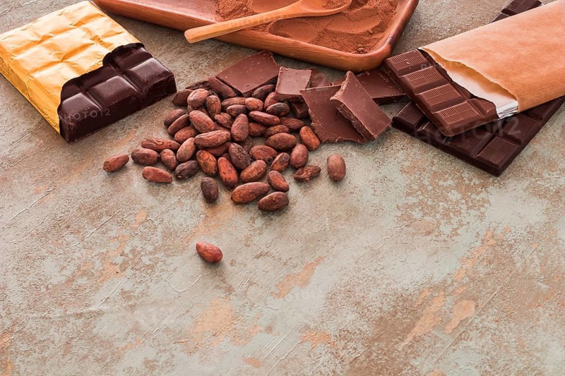 Chocolate bars cocoa beans powder grunge background