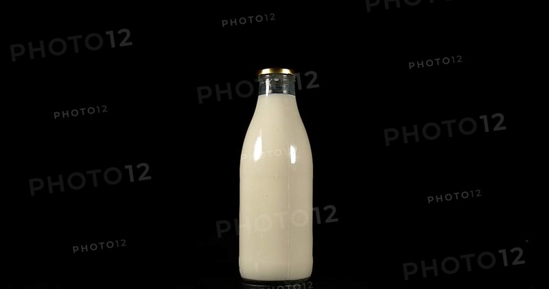 Bottle of Milk against Black Background
