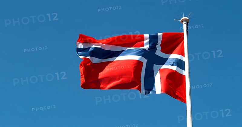 Norvegian Flag Waving in the Wind against blue sky