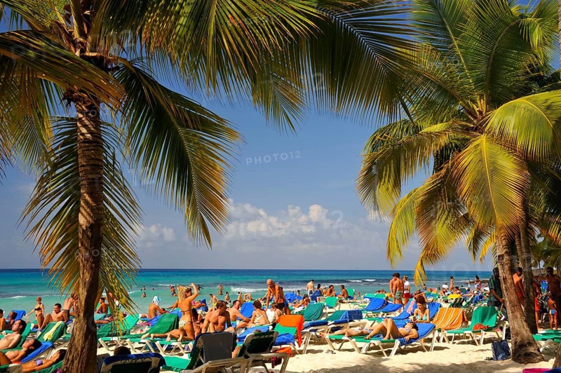 Holidaymakers on a tropical beach, Bayahibe, Dominican Republic, Central America