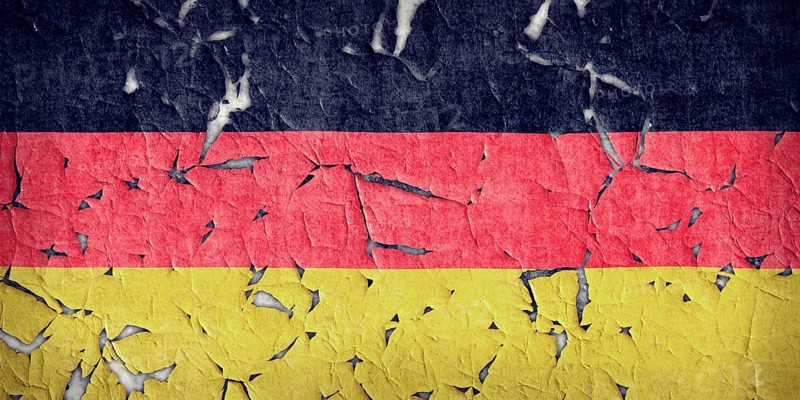 Wall paint of Germany flag is peeling off. Wall with painted Germany flag is peeling off