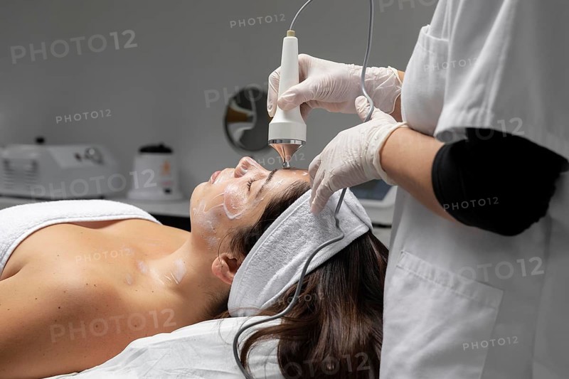 Young woman having facial treatment