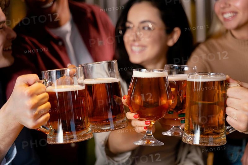 Close up smiley friends with beer mugs
