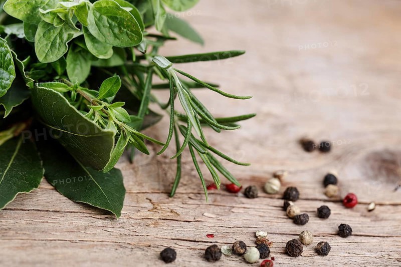 Fresh kitchen herbs in bunches, consisting of thyme, bay leaf, sage and rosemary