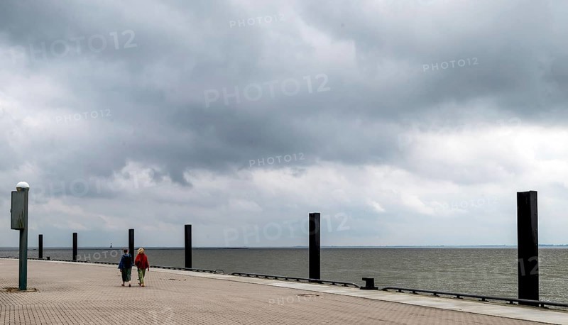 Women walking on the flood pier on the lock island, Wilhelmshaven, Lower Saxony, Germany, Europe