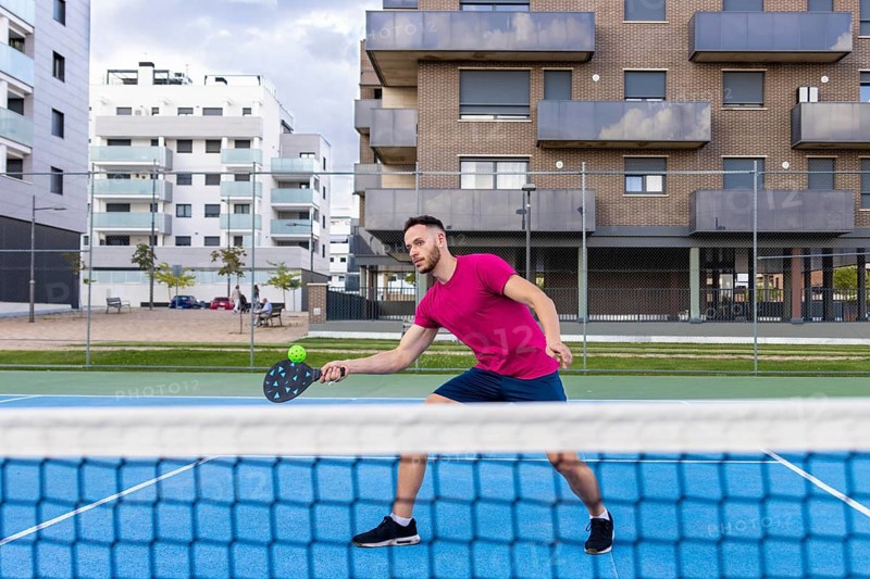 Young Man Pickleball Player Playing Pickleball in Court