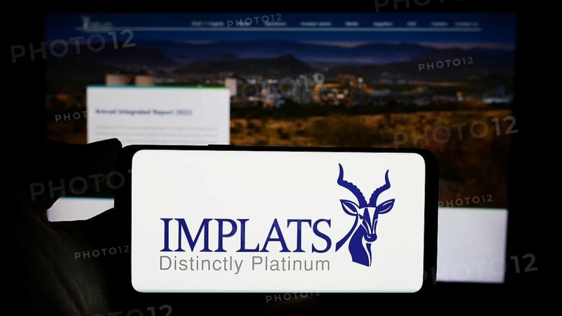 Stuttgart, Germany, 12-07-2023: Person holding cellphone with logo of company Impala Platinum Holdings Limited (Implats) in front of business webpage. Focus on phone display, Europe