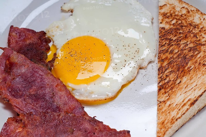 Eggs sunny side up with bacon and toast typical english breakfast