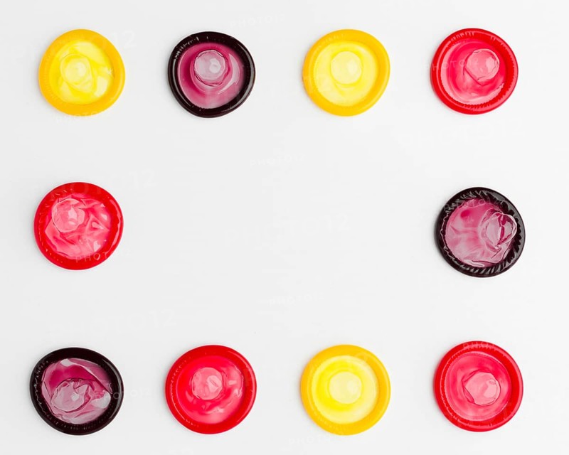 Flat lay arrangement colorful condoms with copy space